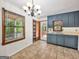 Cozy eat-in kitchen with window and a view to the back deck, featuring tile floors, ample cabinet space, and access to the outside at 2306 Old Lower River Rd, Douglasville, GA 30135