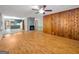 Open-concept living room featuring wood floors, ceiling fan, and brick fireplace at 2306 Old Lower River Rd, Douglasville, GA 30135