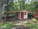 Functional outbuilding with sheltered parking, adding versatility to the property, all set within a natural landscape at 2306 Old Lower River Rd, Douglasville, GA 30135