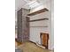 Utility area featuring shelving, a brick accent wall, and access to plumbing at 2306 Old Lower River Rd, Douglasville, GA 30135