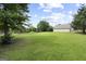 Sprawling backyard offers serene outdoor living with a well-maintained lawn and mature trees at 312 Cattlemans Cir, Mcdonough, GA 30252