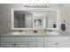 Bathroom featuring double sinks, vanity with storage, updated fixtures, and large mirror at 312 Cattlemans Cir, Mcdonough, GA 30252