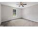 Bedroom with gray carpet, ceiling fan, and a large window at 312 Cattlemans Cir, Mcdonough, GA 30252