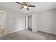 Simple bedroom with neutral carpet, ceiling fan, with a closet with open doors at 312 Cattlemans Cir, Mcdonough, GA 30252