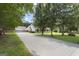 An idyllic home with long driveway, a detached garage, a sprawling lawn, and mature trees at 312 Cattlemans Cir, Mcdonough, GA 30252