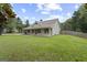 A quaint house with a covered front porch, and spacious lawn, enveloped by mature trees at 312 Cattlemans Cir, Mcdonough, GA 30252
