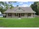 Charming single-story home with a welcoming front porch and manicured lawn at 312 Cattlemans Cir, Mcdonough, GA 30252
