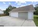 Detached two-car garage with white garage door, concrete driveway, and an entrance door at 312 Cattlemans Cir, Mcdonough, GA 30252