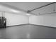 Spacious garage with white walls, sealed concrete floor, and an installed water heater at 312 Cattlemans Cir, Mcdonough, GA 30252