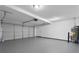 Spacious garage with a large door, white walls, sealed concrete floor and water heater at 312 Cattlemans Cir, Mcdonough, GA 30252