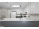 Kitchen features a gray and white color scheme, granite countertops, stainless steel appliances, and modern lighting at 312 Cattlemans Cir, Mcdonough, GA 30252