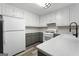 Well-lit kitchen showcases modern appliances, granite countertops, updated cabinetry, and laminate flooring at 312 Cattlemans Cir, Mcdonough, GA 30252