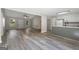 Open-concept living space with vaulted ceiling, laminate flooring, and a view into the updated kitchen at 312 Cattlemans Cir, Mcdonough, GA 30252