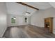 Living room with wood flooring, a fireplace, two windows and a door with light gray paint at 312 Cattlemans Cir, Mcdonough, GA 30252