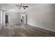 Main bedroom showcasing laminate flooring, a ceiling fan, and an ensuite bathroom at 312 Cattlemans Cir, Mcdonough, GA 30252