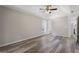 Large primary bedroom boasts laminate flooring, tray ceiling, and access to the ensuite bathroom at 312 Cattlemans Cir, Mcdonough, GA 30252