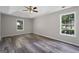 Spacious main bedroom features a tray ceiling, ceiling fan, neutral paint, and updated laminate flooring at 312 Cattlemans Cir, Mcdonough, GA 30252
