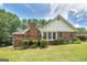 Back exterior featuring a spacious deck, lush lawn, and mature landscaping offering a peaceful retreat at 110 Chardonnay Oaks Dr, Mcdonough, GA 30252