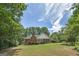 A home featuring a vast lawn, established trees, and a deck create an ideal outdoor living space at 110 Chardonnay Oaks Dr, Mcdonough, GA 30252