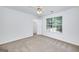 Carpeted bedroom with neutral walls, ceiling fan, closet, and view to the outside at 110 Chardonnay Oaks Dr, Mcdonough, GA 30252