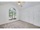 Vaulted bedroom has neutral carpeting and large arched window, bringing in natural light at 110 Chardonnay Oaks Dr, Mcdonough, GA 30252