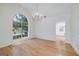 Spacious dining room with hardwood floors, a large window, and elegant chandelier at 110 Chardonnay Oaks Dr, Mcdonough, GA 30252