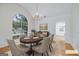 Staged dining room features an oval wood table, chandelier, and view to the kitchen at 110 Chardonnay Oaks Dr, Mcdonough, GA 30252