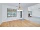 Bright breakfast nook with hardwood floors, a modern chandelier, and access to the backyard at 110 Chardonnay Oaks Dr, Mcdonough, GA 30252