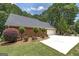 Lush landscaping, new roof, and driveway lead to an immaculate 2-car garage and beautiful outdoor scenery at 110 Chardonnay Oaks Dr, Mcdonough, GA 30252