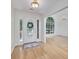 Bright foyer with hardwood floors, chandelier, and a large window adds charm to this home's entry at 110 Chardonnay Oaks Dr, Mcdonough, GA 30252