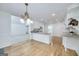 Bright kitchen featuring an elegant chandelier, granite counters, and stainless steel appliances at 110 Chardonnay Oaks Dr, Mcdonough, GA 30252