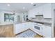Clean, white kitchen features a breakfast bar, hardwood floors, and modern appliances at 110 Chardonnay Oaks Dr, Mcdonough, GA 30252