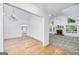 Bright living room features hardwood floors, fireplace, large windows, and access to the kitchen at 110 Chardonnay Oaks Dr, Mcdonough, GA 30252