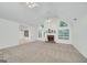 Living room features a vaulted ceiling, a brick fireplace, ceiling fans, and many windows at 110 Chardonnay Oaks Dr, Mcdonough, GA 30252