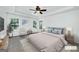 Staged primary bedroom with tray ceiling, ample seating, and natural light at 110 Chardonnay Oaks Dr, Mcdonough, GA 30252
