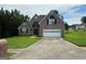 Attractive two-story brick home boasting a well-kept lawn, a spacious driveway, and a two-car garage at 12189 Lauren Way, Fayetteville, GA 30215