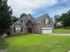 Beautiful two-story brick home with a manicured lawn, double-door entry, and attached two-car garage at 12189 Lauren Way, Fayetteville, GA 30215