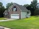 Well-maintained two-story brick home with a two-car garage and lush green lawn with mature trees at 12189 Lauren Way, Fayetteville, GA 30215