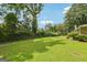 Spacious backyard with lush green grass, mature trees and manicured hedges at 3212 Georgian Woods Cir, Decatur, GA 30034