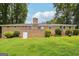 Large backyard featuring a brick home exterior, mature trees, and well-maintained lawn at 3212 Georgian Woods Cir, Decatur, GA 30034
