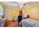 Bedroom features yellow walls, hardwood floors, and a ceiling fan at 3212 Georgian Woods Cir, Decatur, GA 30034
