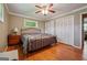 Bedroom featuring hardwood floors, a metal bed frame, and large closets at 3212 Georgian Woods Cir, Decatur, GA 30034