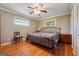 Bedroom featuring hardwood floors and a metal bed frame at 3212 Georgian Woods Cir, Decatur, GA 30034