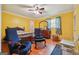 Bright bedroom featuring yellow walls, hardwood floors, and a ceiling fan at 3212 Georgian Woods Cir, Decatur, GA 30034