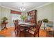 Formal dining room featuring a classic china cabinet and set dining table with a flower centerpiece at 3212 Georgian Woods Cir, Decatur, GA 30034