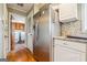Bright kitchen with stainless steel refrigerator, granite countertops, and easy access to laundry area at 3212 Georgian Woods Cir, Decatur, GA 30034