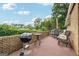 Outdoor patio area featuring a grill, table, chairs, and lush green landscaping at 3212 Georgian Woods Cir, Decatur, GA 30034