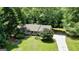 Aerial view of the home showing a spacious front yard, mature trees, and a long driveway at 1624 Hampton Locust Grove Rd, Locust Grove, GA 30248