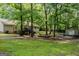 Spacious backyard with a deck, mature trees, and a storage shed at 1624 Hampton Locust Grove Rd, Locust Grove, GA 30248