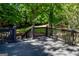 Spacious wooden deck surrounded by lush greenery and mature trees at 1624 Hampton Locust Grove Rd, Locust Grove, GA 30248